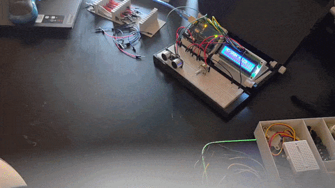 An Arduino with an LCD showing distance as a moving waveform.